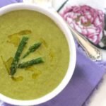 overhead photo of healthy asparagus soup recipe on a purple cloth