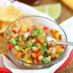 closeup rhubarb salsa in a red basket with chips